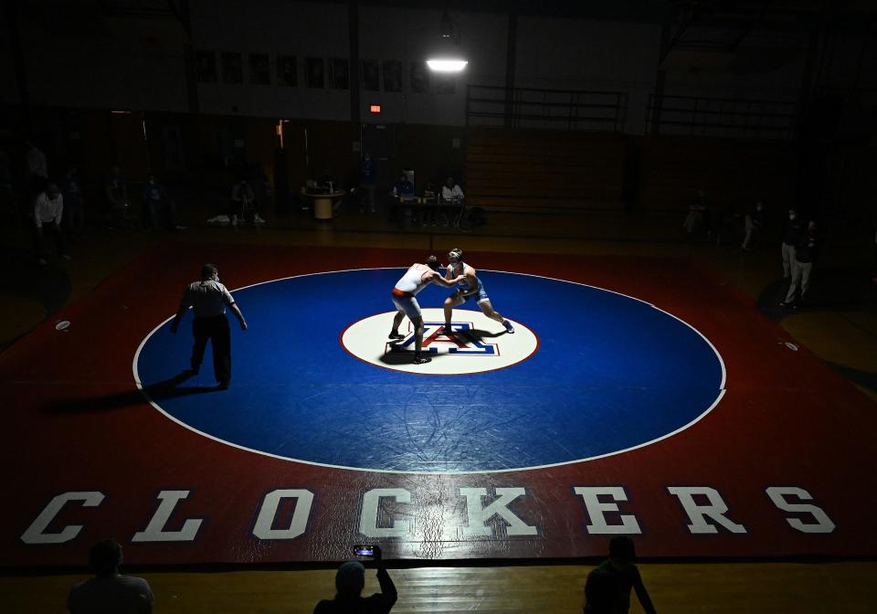 Ashland's Patrick DesLauriers (right) and Wayland's Ryan Fennelly wrestle in a 220 lbs. bout at Ashland Middle School, Jan. 13, 2021.