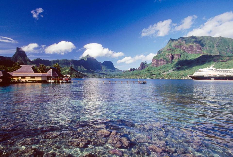 Pile dwellings with a cruise ship, Mo'orea