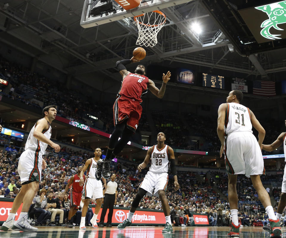 Miami Heat's LeBron James (6) dunks against the Milwaukee Bucks in the first half of an NBA basketball game Saturday, March 29, 2014, in Milwaukee. (AP Photo/Jeffrey Phelps)