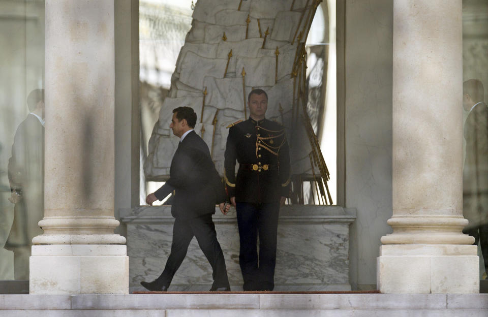 Outgoing French President Nicolas Sarkozy walks along the hallway at Elysee palace in Paris, Monday May 7, 2012. France handed the presidency to leftist Francois Hollande, a champion of government stimulus programs who says the state should protect the downtrodden, a victory that could deal a death blow to the drive for austerity that has been the hallmark of Europe in recent years. (AP Photo/Jacques Brinon)