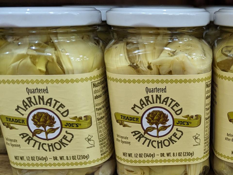 Jars of Trader Joe's quartered marinated artichokes.