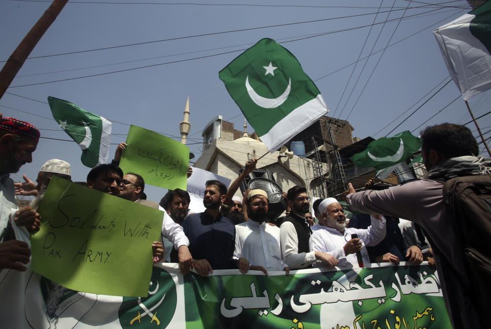 People take part in a rally to show solidarity with Pakistan's army in Peshawar, Pakistan, Friday, May 19, 2023. Pakistan's former Prime Minister Imran Khan dialed down his campaign of defiance Friday, saying he would allow a police search of his residence over allegations he was harboring suspects wanted in recent violence and appearing before a court in his hometown to seek protection from arrest in multiple terrorism cases. (AP Photo/Muhammad Sajjad)