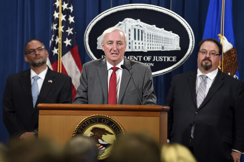 Deputy Attorney General Jeffrey Rosen, center, flanked by Hugh Hurwitz, left, the acting director of the Bureau of Prisons, and David Muhlhausen, director of the National Institute of Justice, speaks during a news conference at the Justice Department in Washington, Friday, July 19, 2019, on developments in the implementation of the First Step Act. About 2,200 federal inmates will be released by the federal Bureau of Prisons under the criminal justice reform measure signed into law last year by President Donald Trump. (AP Photo/Susan Walsh)