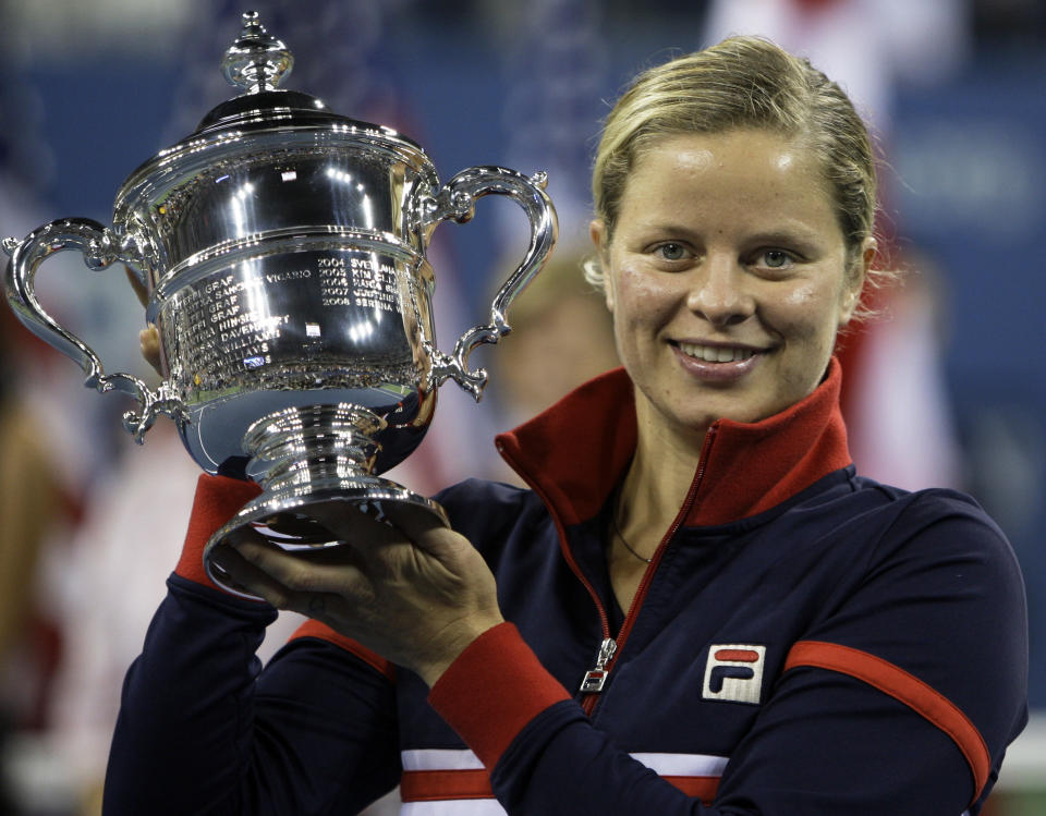 FILE - In this Sept. 13, 2009, file photo, Kim Clijsters holds the trophy after winning the women's championship over Caroline Wozniacki, at the U.S. Open tennis tournament in New York. Four-time Grand Slam champion Kim Clijsters is planning another comeback. A mother of three, the Belgian who retired after the 2012 U.S. Open wants a new challenge, she told the WTA in an interview on its website on Thursday, Sept. 12, 2019. (AP Photo/Charles Krupa, FIle)