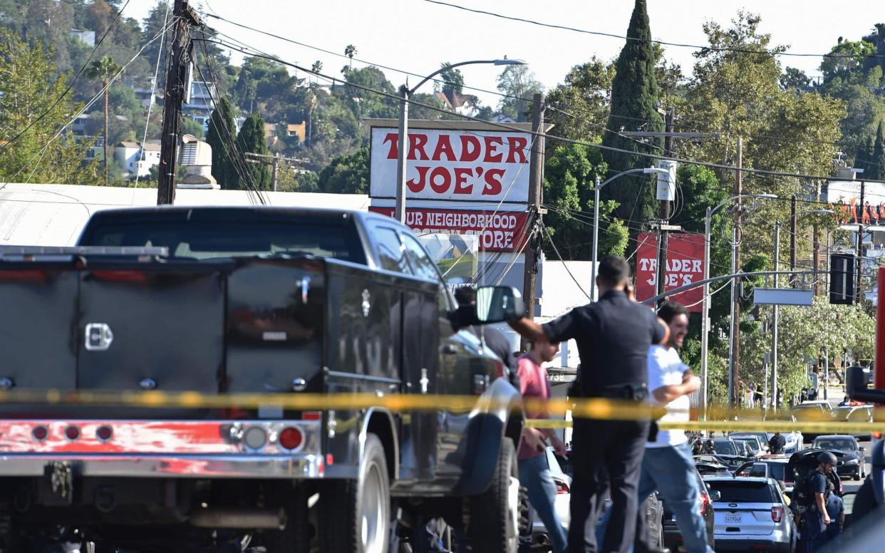 Police officers guard a supermarket with a barricaded suspect in Silverlake, Los Angeles - AFP