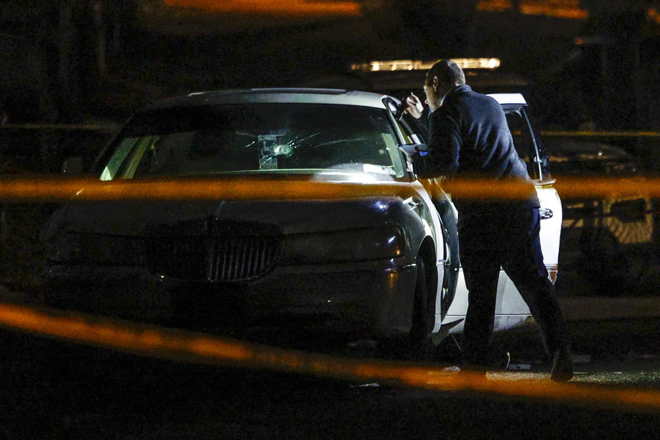 Police officers investigate a police involved shooting Thursday evening, Feb. 15, 2024, in Philadelphia. (Steven M. Falk/The Philadelphia Inquirer via AP)