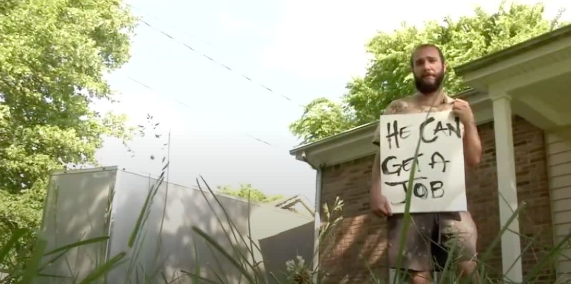 Tyler Blair, of Bellevue, Tenn. was so fed up with a panhandler in his neighborhood he stood beside him with a sign that read, "He Can Get A Job." (Photo: Fox17)