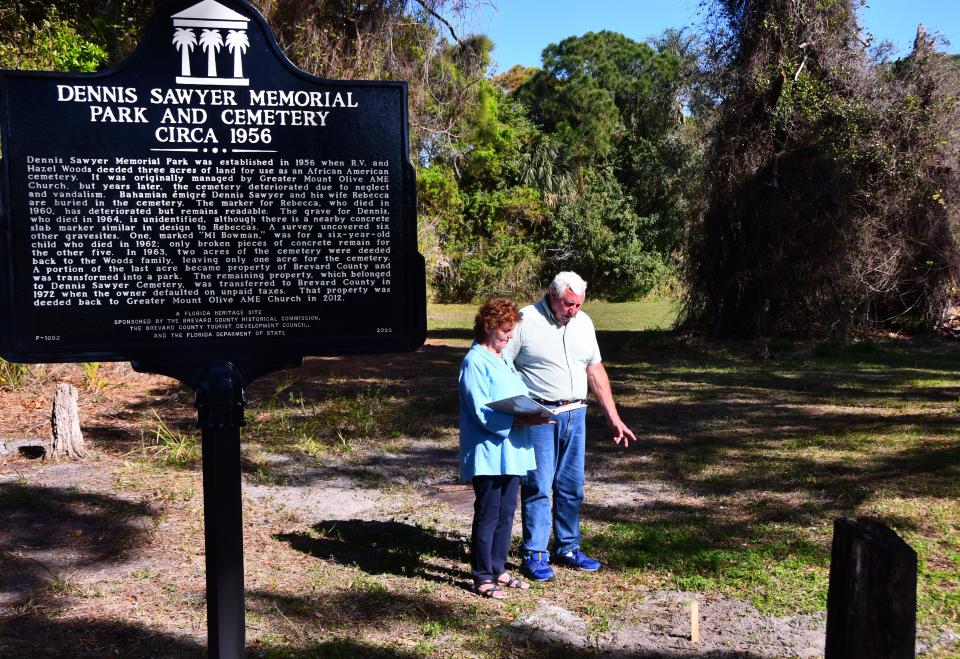 Roz Foster and Jack Ratterman, commissioners for their respective districts for the Brevard County Historical Commission, look over burial sites at the Dennis Sawyer Memorial Park and Cemetery on Merritt Island. The cemetery opened in 1956, with acreage donated by R.V. and Hazel Woods for a place where Black residents could be buried.