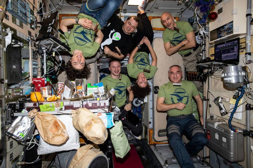 The six member Expedition 61 crew is gathered for a meal 