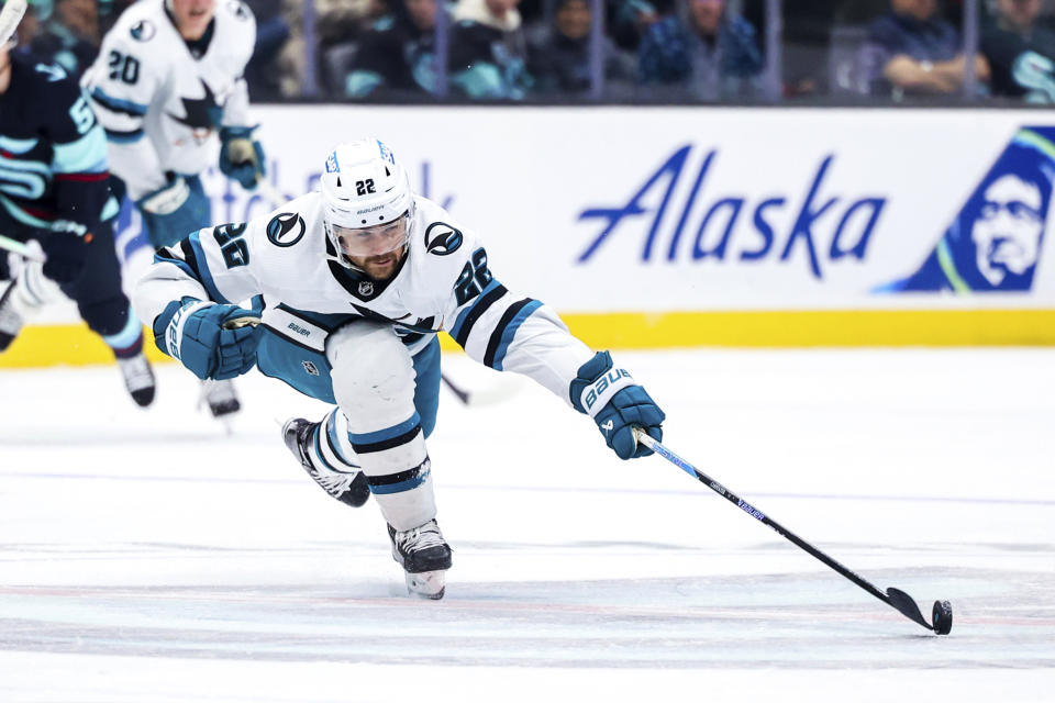 San Jose Sharks center Ryan Carpenter passes the puck during the third period of the team's NHL hockey game against the Seattle Kraken on Wednesday, Nov. 22, 2023, in Seattle. (AP Photo/Maddy Grassy)