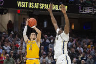 Kent State's Giovanni Santiago, left, shoots over Akron's Sammy Hunter, right, during the second half of an NCAA college basketball game in the championship of the Mid-American Conference tournament, Saturday, March 16, 2024, in Cleveland. (AP Photo/Phil Long)