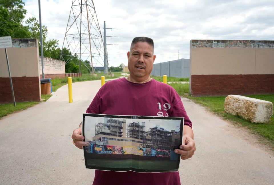 Martinez shows a photo of his mural that was removed and painted over at the decommissioned Holly Power Plant.