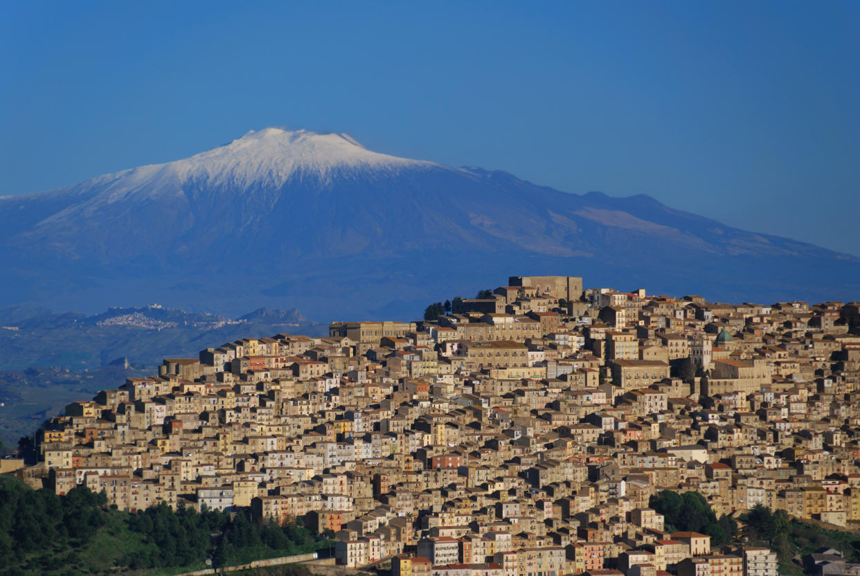 Little village of Gangi and  volcano Etna on background.