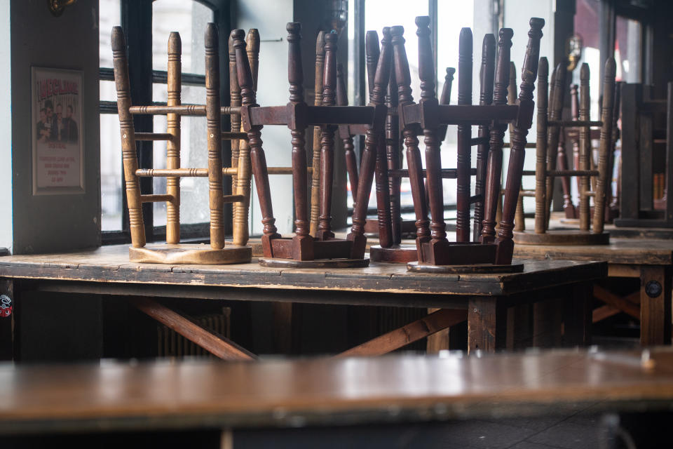 Bar stools up on tables in a closed pub in New Cross, south London, following the government ordered closure of bars, clubs and restaurants due to the Coronavirus outbreak.