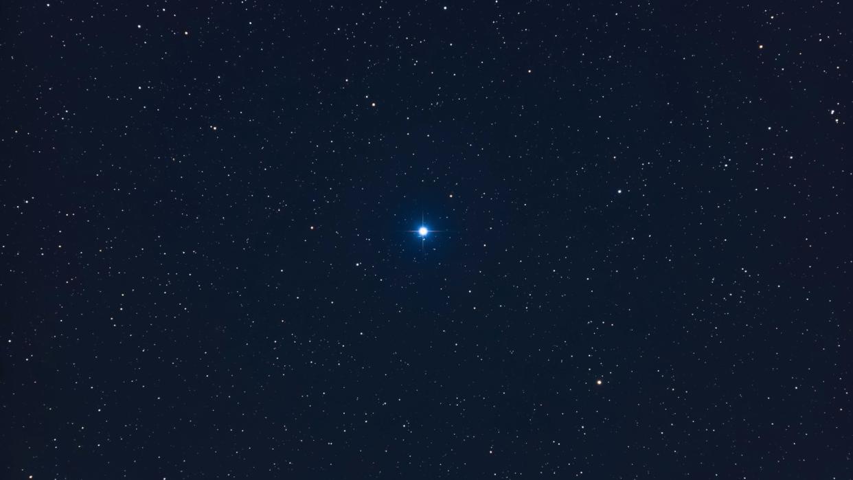  A bright blue star in the night sky. 