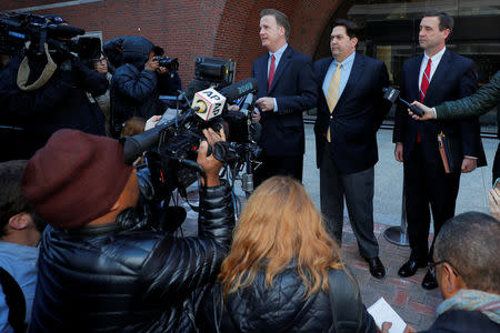 William Ferguson, former women's volleyball coach at Wake Forest University facing charges in a nationwide college admissions cheating scheme, and his lawyers talk to reporters as they arrive at the federal courthouse in Boston, Massachusetts, U.S., March 25, 2019. REUTERS/Brian Snyder