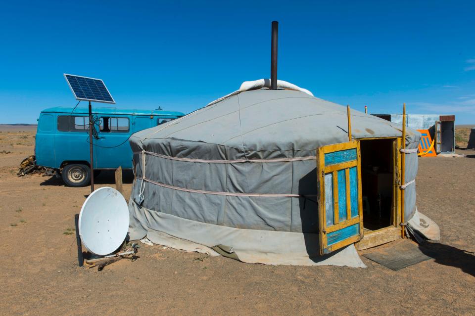 A herder ger with a satellite dish and solar panel.