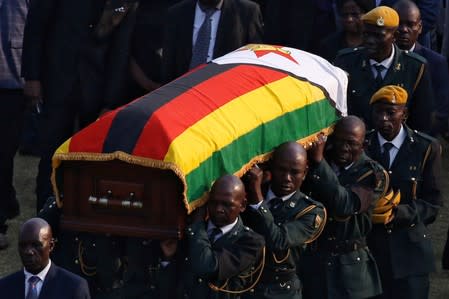 A casket carrying the remains of former Zimbabwean president Robert Mugabe is carried to the military chopper after his body lied in state at the Rufaro stadium