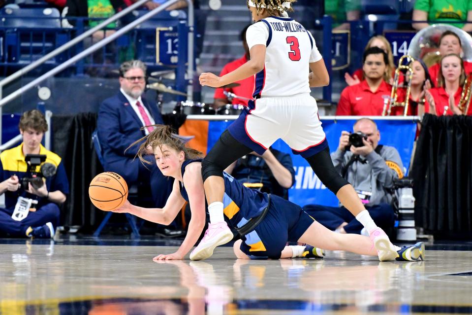 Marquette guard Mackenzie Hare passes the ball as Ole Miss guard Kennedy Todd-Williams defends in the first half at the Purcell Pavilion on Saturday.