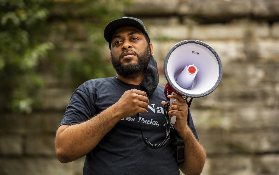 State Rep. Charles Booker paused with emotion while speaking to the crowd gathered at Tyler Park during the 'March to Justice' protest march on Saturday, Oct. 10, 2020