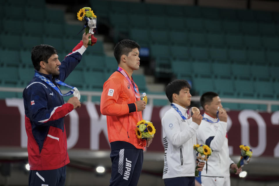 From left, silver medalist Lasha Shavdatuashvili of Georgia, gold medalist Shohei Ono of Japan, bronze medalists An Changrim of South Korea and Tsogtbaatar Tsend-Ochir of Mongolia pose after the medal ceremony for men's -73kg judo, at the 2020 Summer Olympics in Tokyo, Japan, Monday, July 26, 2021. (AP Photo/Vincent Thian)