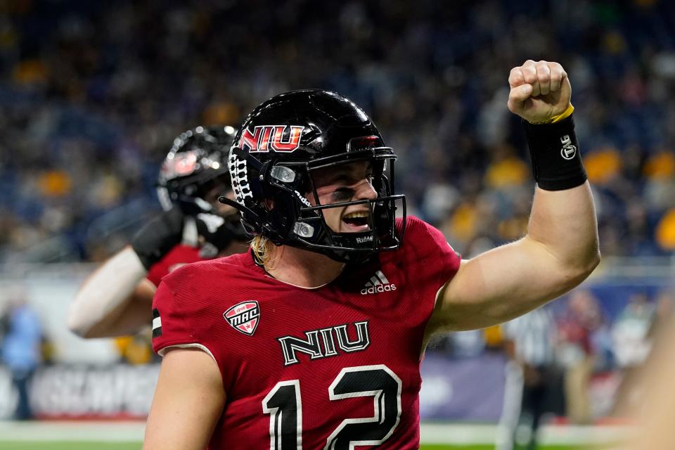 Northern Illinois quarterback Rocky Lombardi reacts towards the fans after scoring on a 1-yard run during the first half of an NCAA college football game against Kent State, Saturday, Dec. 4, 2021, in Detroit. (AP Photo/Carlos Osorio)