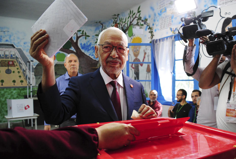 President of the Islamist party Ennahda and candidate for the Parliamentary election Rached Ghannouchi votes in a polling station south of Tunis, Tunisia, Sunday, Oct. 6, 2019. Tunisians are electing a new parliament Sunday amid a tumultuous political season, with a moderate Islamist party and a jailed tycoon's populist movement vying to come out on top of a crowded field. (AP Photo/Hassene Dridi)