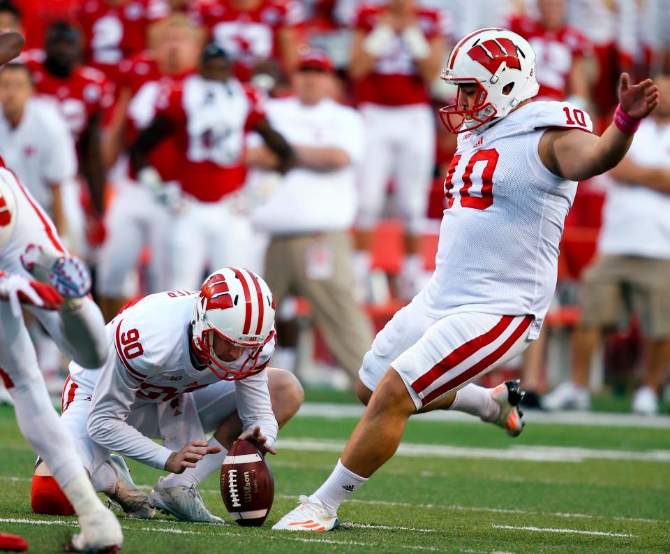 Wisconsin kicker Rafael Gaglianone (10) kicks the go-ahead and eventual game-winning field goal with Drew Meyer (90) holding, during the second half of an NCAA college football game against Nebraska in Lincoln, Neb., Saturday, Oct. 10, 2015. Wisconsin won 23-21. (AP Photo/Nati Harnik)