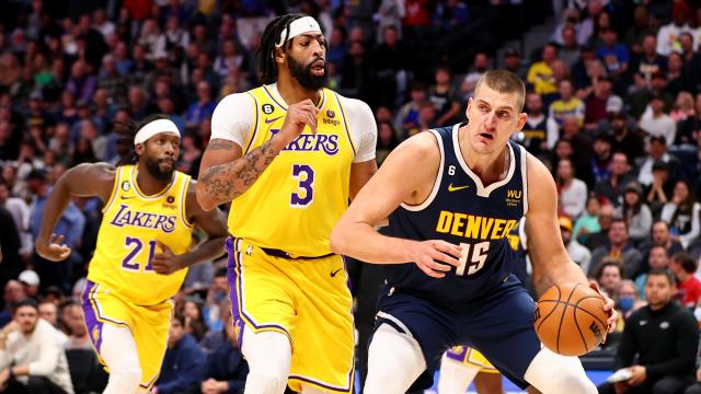   Nikola Jokic #15 of the Denver Nuggets drives against Anthony Davis #3 of the Los Angeles Lakers at Ball Arena  