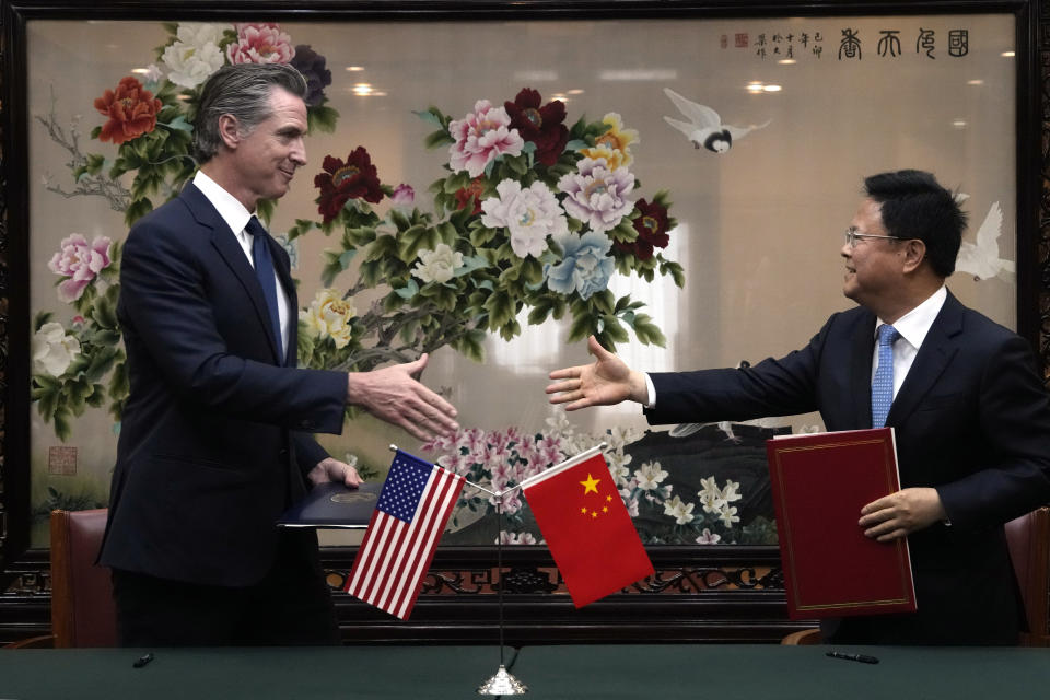 California Gov. Gavin Newsom, left, shakes hands with Zheng Shanjie, head of China's National Development and Reform Commission, after they signed a Memorandum of Understanding in Beijing, Wednesday, Oct. 25, 2023. Newsom also met with China's senior most diplomat Wang Yi on Wednesday and displayed a brief moment of friendliness that stands in sharp contrast to the dialogue between the U.S. and China in recent years. (AP Photo/Ng Han Guan)