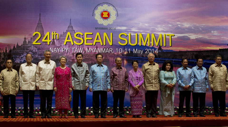 Leaders of Association of Southeast Asian Nations pose for a photograph ahead of a dinner hosted by Myanmar President Thein Sein during the 24th ASEAN Summit in Naypyitaw, Myanmar, Saturday, May 10 2014. Leaders from left, Laos President Choummaly Sayasone, Philippines President Benigno "Noynoy" Aquino III, Singaporean Prime Minister Lee Hsien Loong, and his spouse Ho Ching,Thailand ministry of Foreign Affaires, permanent secretary Sihasak Phuangketkeow, Vietnamese President Truong Tan Sang, Myanmar President Thein Sein, and his spouse Khin Khin Win, Malaysian Prime Minister Najib Razak, and his spouse Rosmah Mansor, Sultan of Brunei Hassanal Bolkiah, Cambodian Prime minister Hun Sen, Indonesian President Susilo Bambang Yudhoyono.(AP Photo/Gemunu Amarasinghe)