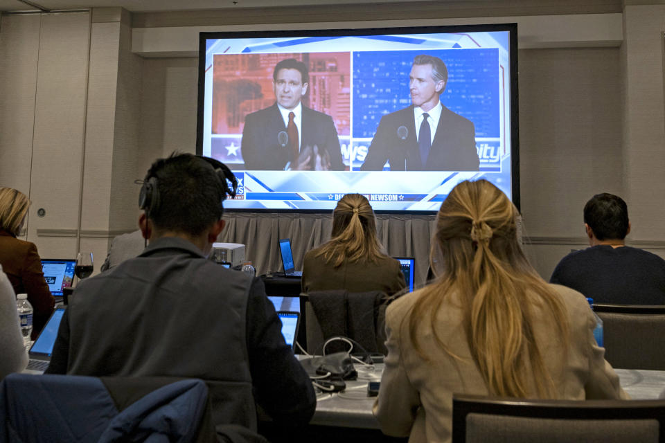 Ron DeSantis and Gavin Newsom appear on screen from the press room during November’s debate