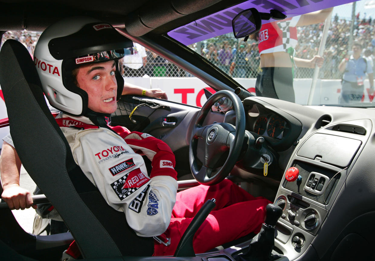 Actor Frankie Muniz straps himself into his car prior to the start of the Pro-Celebrity race at the Toyota Grand Prix of Long Beach, Saturday, April 9, 2005, in Long Beach, Calif. Muniz won the race for the celebrities. (AP Photo/Mark J. Terrill)