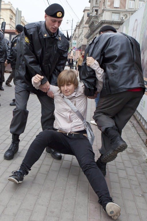 Anastasiya Rybachenko is detained by police officers during an opposition rally in Moscow. Later when police searched her apartment while she was in Europe, Rybachenko decided not to come back