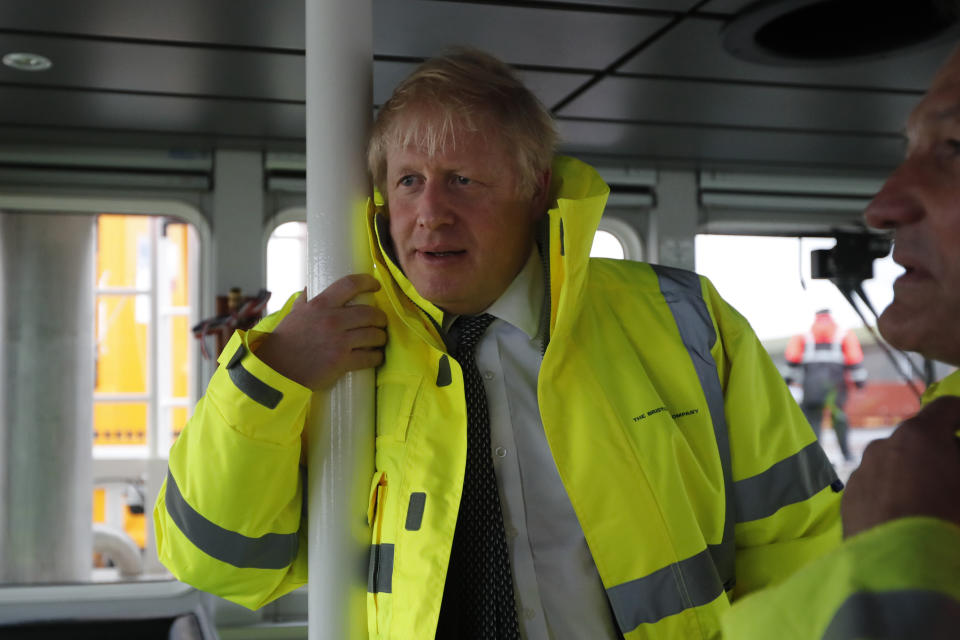 Britain's Prime Minister Boris Johnson looks out from the steering cabin of tug boat during a General Election campaign trail stop in the port of Bristol, England, Thursday, Nov. 14, 2019. Britain goes to the polls on Dec. 12. (AP Photo/Frank Augstein, Pool)