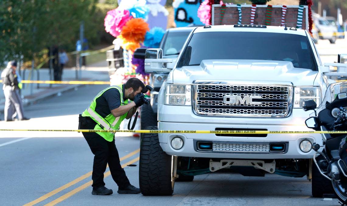 Investigators take photos of the truck that went out of control at the Raleigh Christmas Parade injuring at least one person Saturday, Nov. 19, 2022.