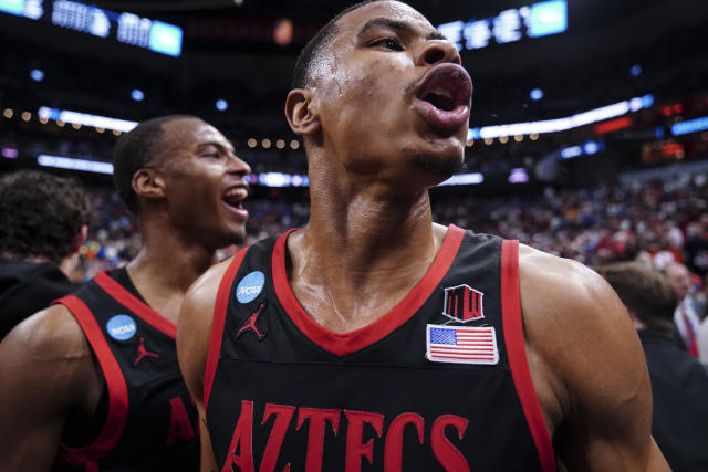 San Diego State forward Keshad Johnson, right, celebrates with teammates after a Sweet 16 round college basketball game in the South Regional of the NCAA Tournament against Alabama, Friday, March 24, 2023, in Louisville, Ky. San Diego State won 71-64. (AP Photo/John Bazemore)