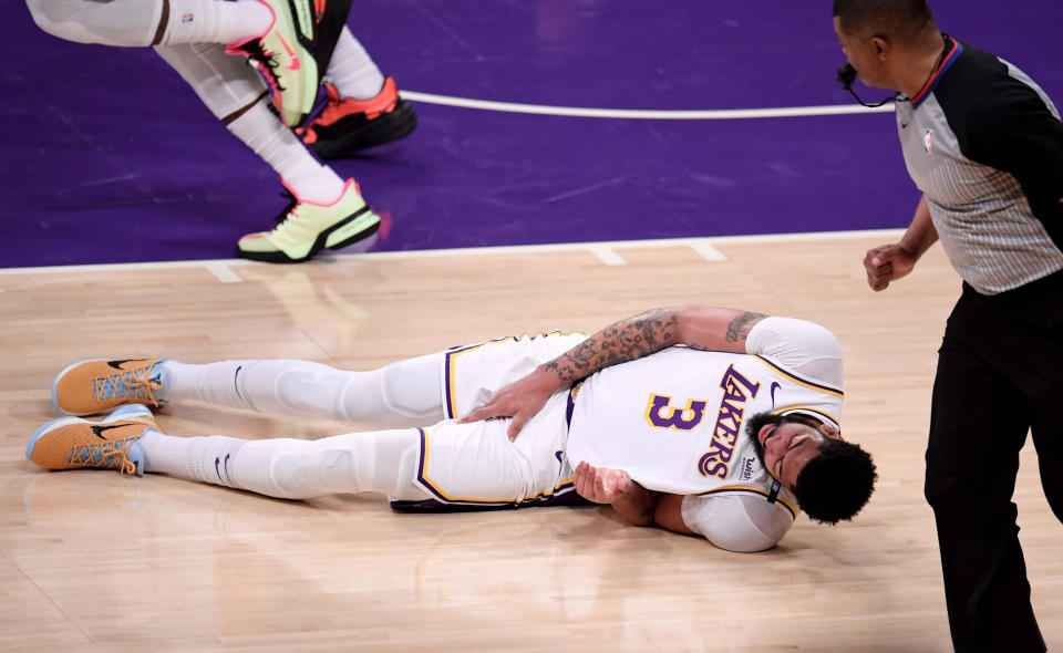 Anthony Davis #3 of the Los Angeles Lakers falls to the floor grabbing his leg against the Phoenix Suns in the first half of game four of the Western Conference First Round NBA Playoff basketball game at the Staples Center in Los Angeles on Sunday, May 30, 2021. (Photo by Keith Birmingham/MediaNews Group/Pasadena Star-News via Getty Images)