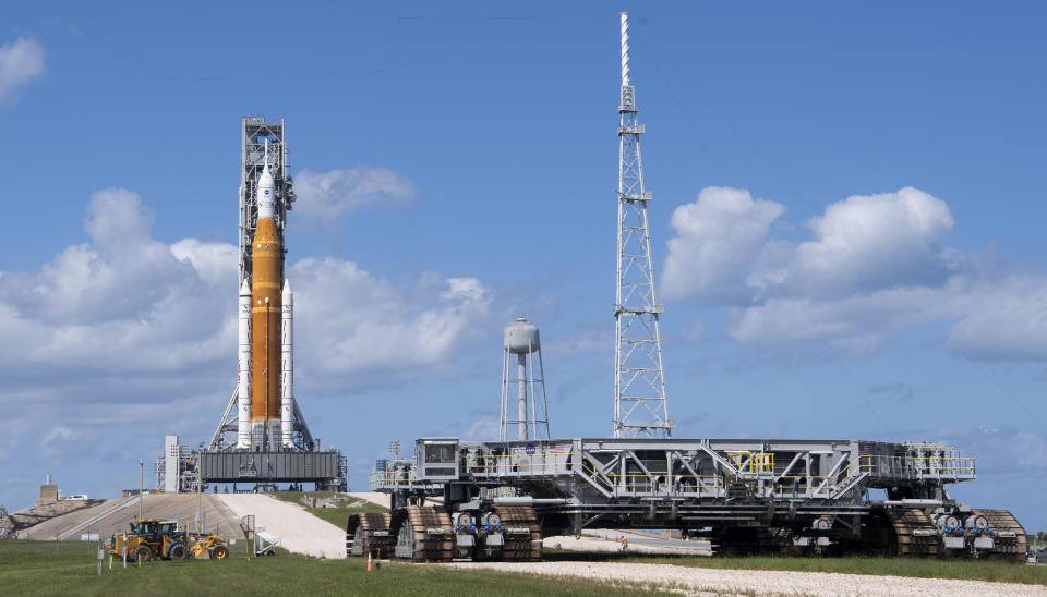 In this photo provided by NASA, Crawler Transporter-2 is seen outside the gates at Launch Pad 39B as teams configure systems for rolling NASA's moon rocket back to the Vehicle Assembly Building on Sept. 24, 2022, at NASA's Kennedy Space Center in Cape Canaveral, Fla. NASA mission managers decided Monday, Sept. 26, to move its moon rocket off the launch pad and into shelter due to Hurricane Ian's uncertain path. (Joel Kowsky/NASA via AP)