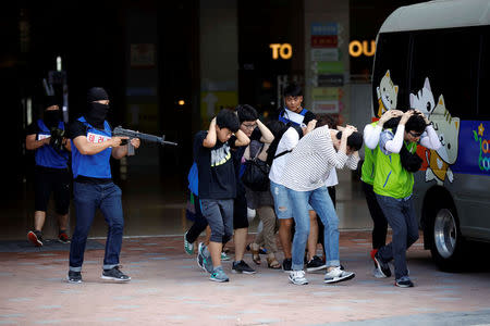 People take part in an anti-terror drill as a part of the Ulchi Freedom Guardian exercise in Goyang, South Korea August 21, 2017. REUTERS/Kim Hong-Ji