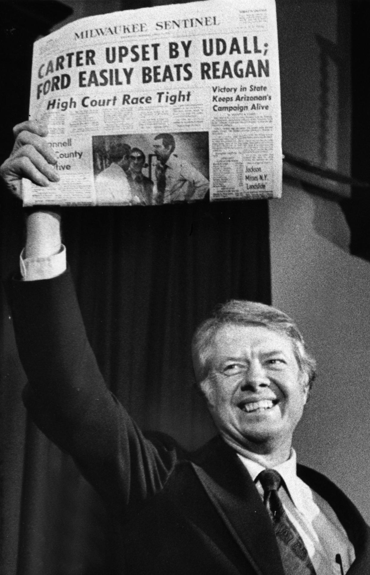 Jimmy Carter holds up an early edition of the April 7, 1976, Milwaukee Sentinel, the day after he pulled out a close victory in the Wisconsin Primary over Republican Democrat Morris Udall. This photo was published in the April 7, 1976, Milwaukee Journal.