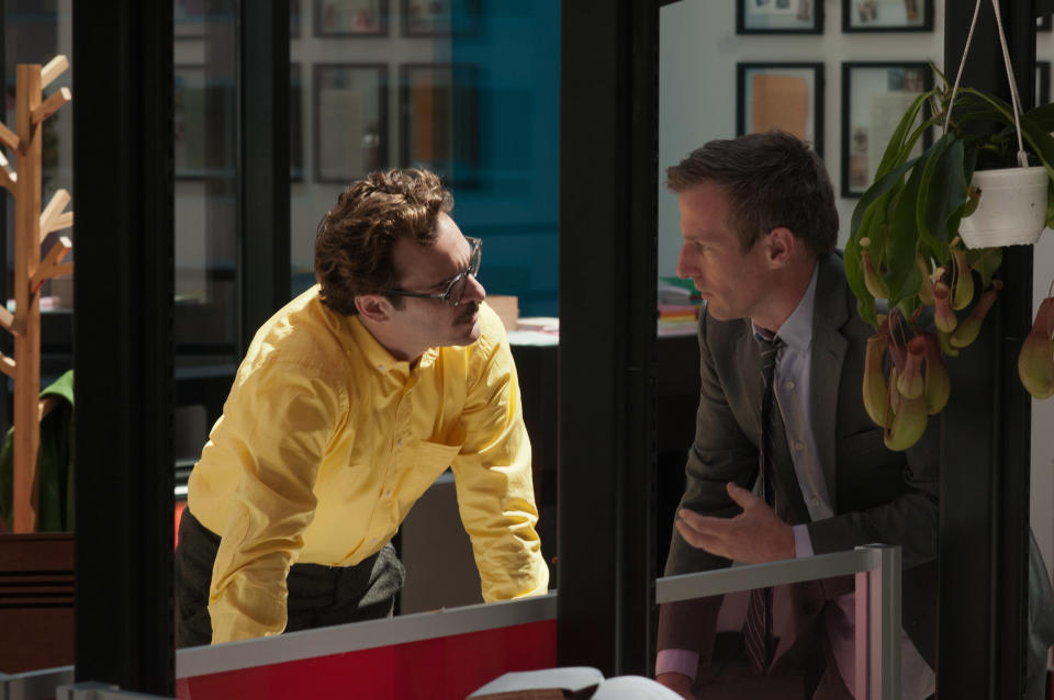 This image released by Warner Bros. Pictures shows Joaquin Phoenix, left, and director Spike Jonze on the set of "Her." The film has been selected as the best film of the year by the National Board of Review and Phoenix was nominated for a Golden Globe for best actor in a motion picture musical or comedy. (AP Photo/Warner Bros. Pictures, Merrick Morton)