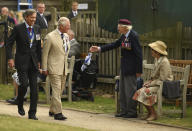 A veteran stands to greet Britain's Prince Charles as he arrives for the national service of remembrance marking the 75th anniversary of V-J Day at the National Memorial Arboretum in Alrewas, England, Saturday Aug. 15, 2020. Following the surrender of the Nazis on May 8, 1945, V-E Day, Allied troops carried on fighting the Japanese until an armistice was declared on Aug. 15, 1945. (Oli Scarff/PA via AP)