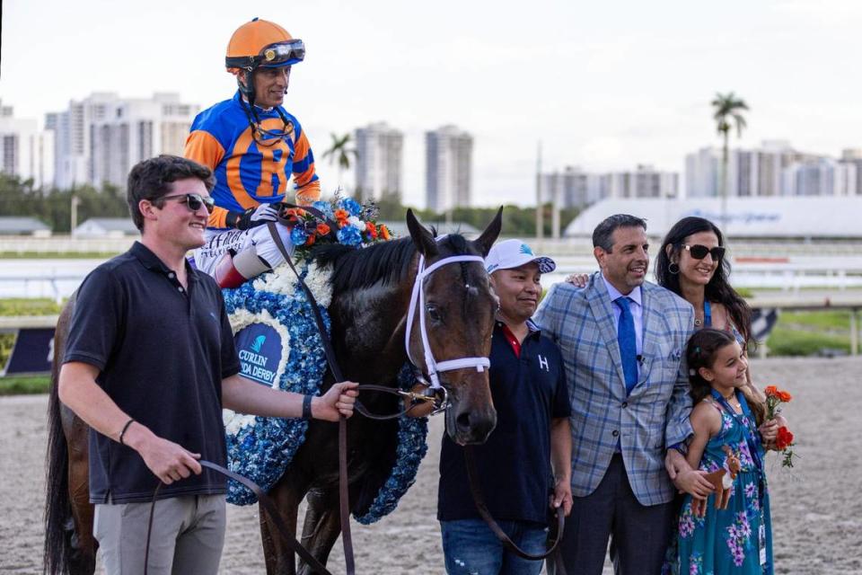 John R. Velazquez poses for a photo with owner Mike Repole and his family after placing first in the 73rd running of the Florida Derby with ‘Fierceness’ #10 at Gulfstream Park in Hallandale, Florida, on Saturday, March 30, 2024.