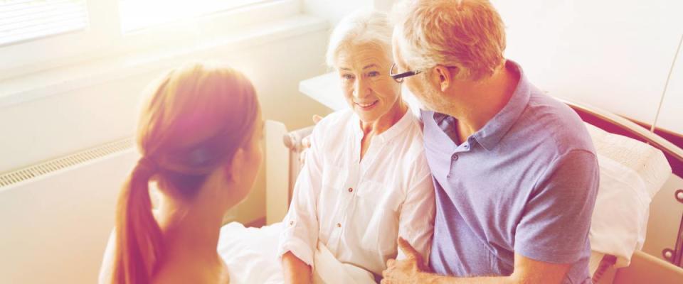 adult child with elderly parents, mother in hospital bed