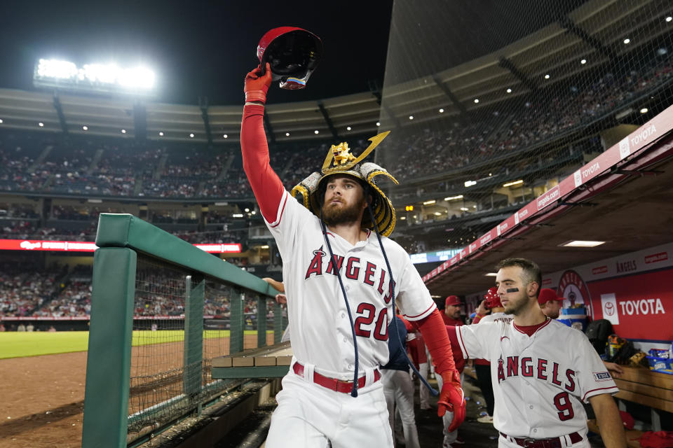 Los Angeles Angels' Jared Walsh (20) celebrates in the dugout after hitting a home run during the ninth inning of a baseball game against the Detroit Tigers in Anaheim, Calif., Saturday, Sept. 16, 2023. Logan O'Hoppe also scored. (AP Photo/Ashley Landis)