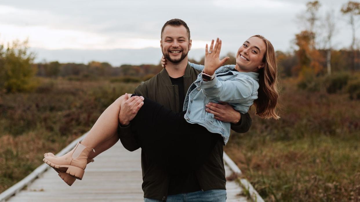 a man and woman holding a baby