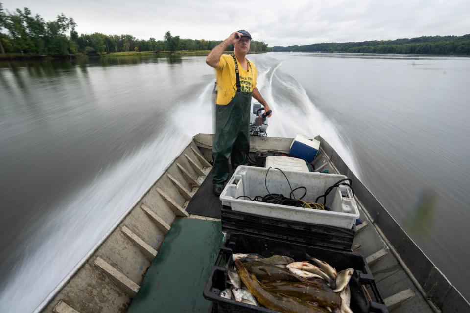Mike Valley drives his 25-foot boat while out checking his fishing nets Sept. 26 on the Mississippi River near Cassville. Valley is one of a dwindling number of commercial fishermen left on the upper Mississippi River.