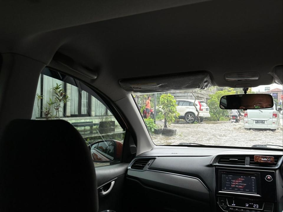 A view from the inside of a car to the road in Bali.