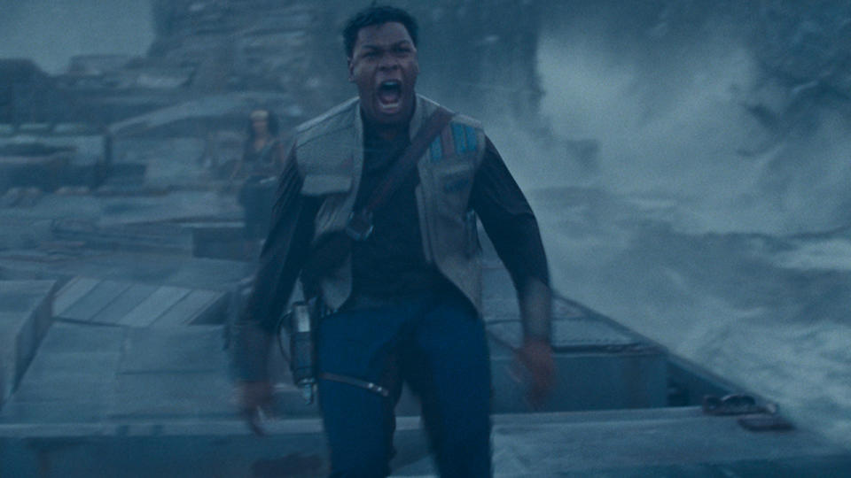 John Boyega yelling while standing on flooded Imperial wreckage as Naomi Ackie stands in the background in Star Wars: The Rise of Skywalker.